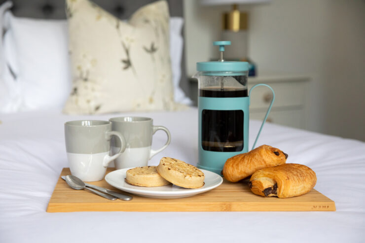 scones and french press on bed - simple getaway