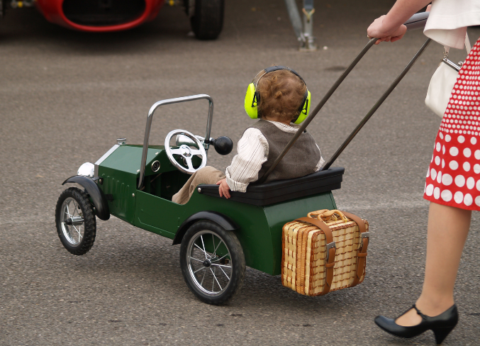 Goodwood retro festival family and child in a vintage replica car